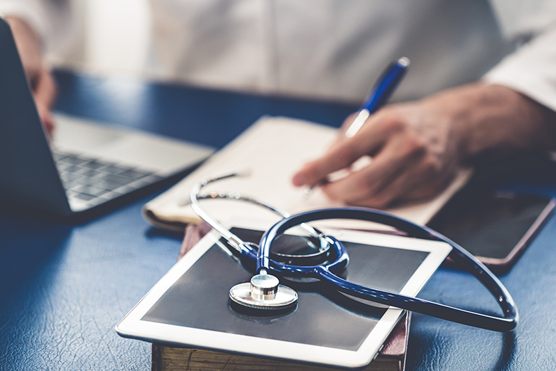 Doctor working in hospital office. Medical healthcare concept.